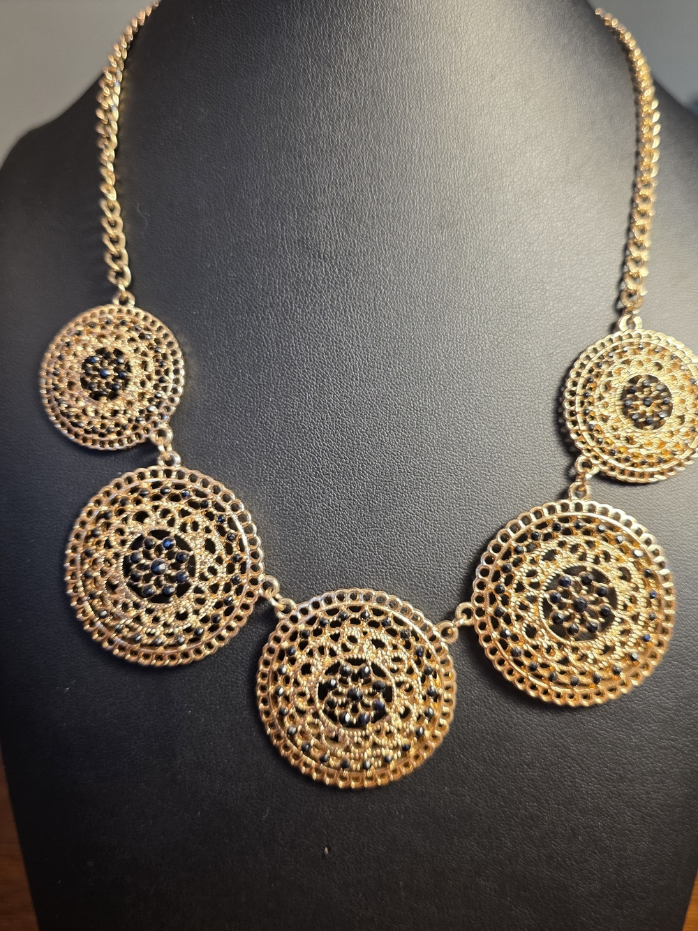 Gold Filigree Disc Statement Necklace With Black Rhinestones.